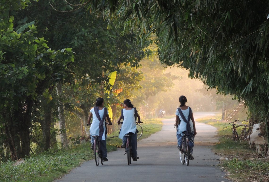 Indian ladies riding bicycles in Majuli, Assam